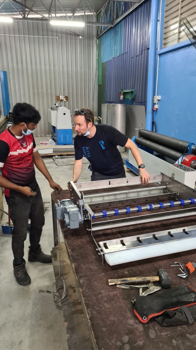 Alfa engineer reviewing fabrication details with a local workshop team